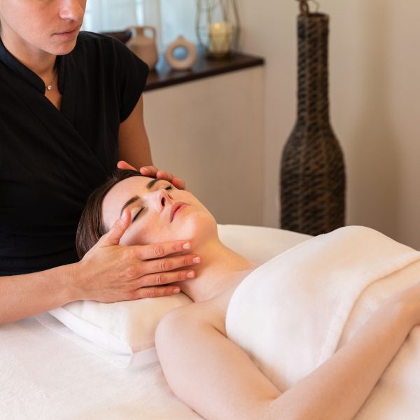 A woman receiving a facial treatment at the InterContinental Genève spa.